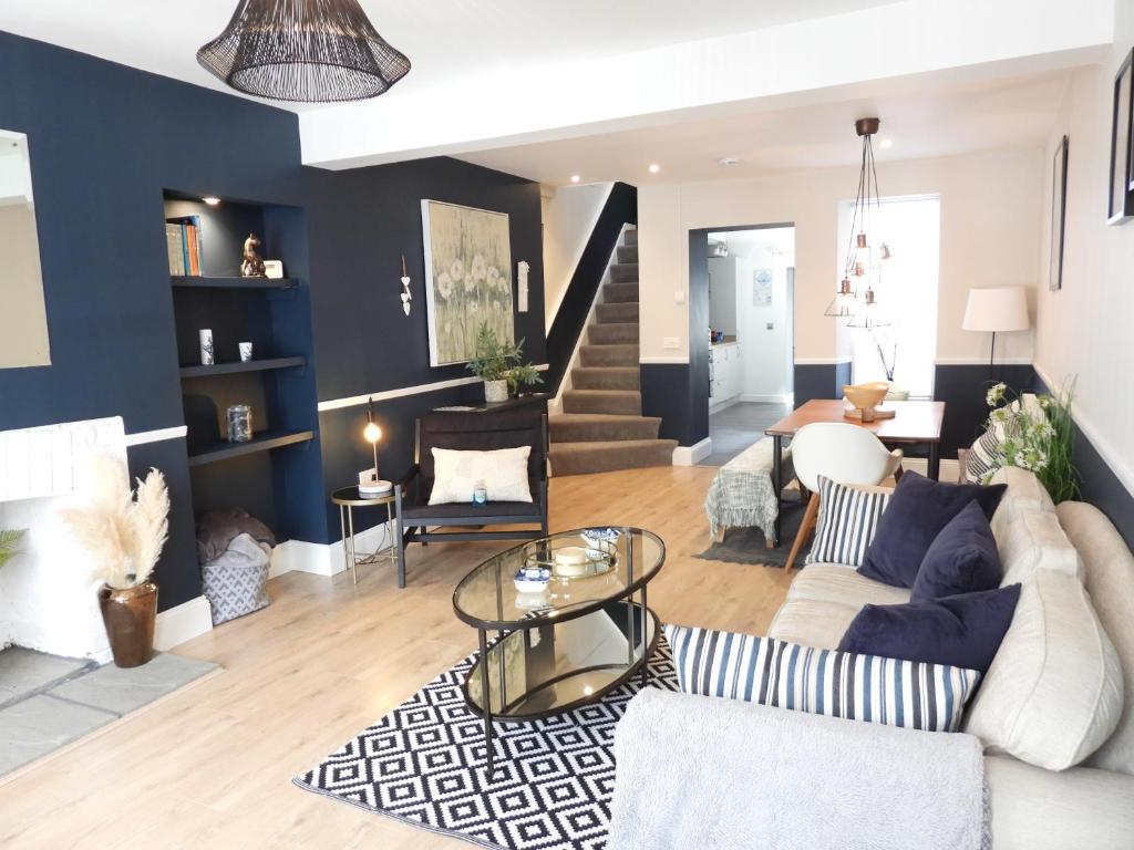 a living room with a couch and a table at Aubrey Cottage in Cowbridge