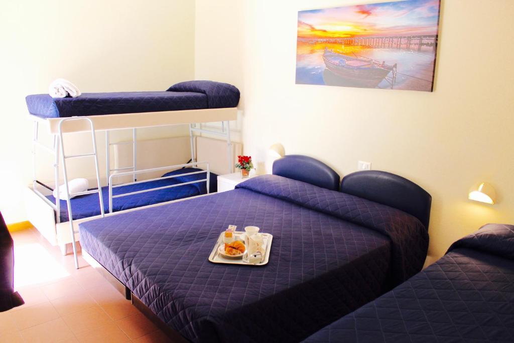 Postel nebo postele na pokoji v ubytování Hotel Fedora Rimini