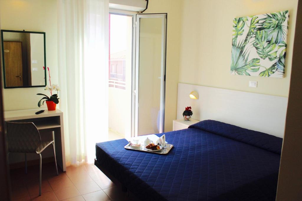 Postel nebo postele na pokoji v ubytování Hotel Fedora Rimini