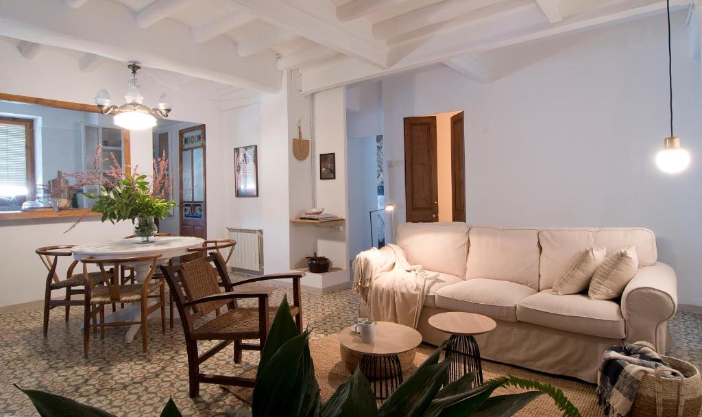 uma sala de estar com um sofá e uma mesa em L'Hostatgeria del Celler em Porrera