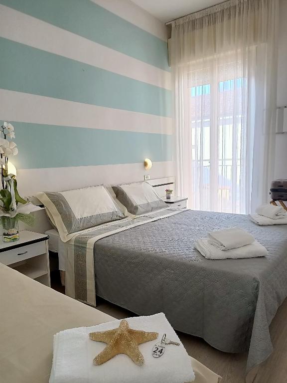 Postel nebo postele na pokoji v ubytování Hotel Cristoforo Colombo