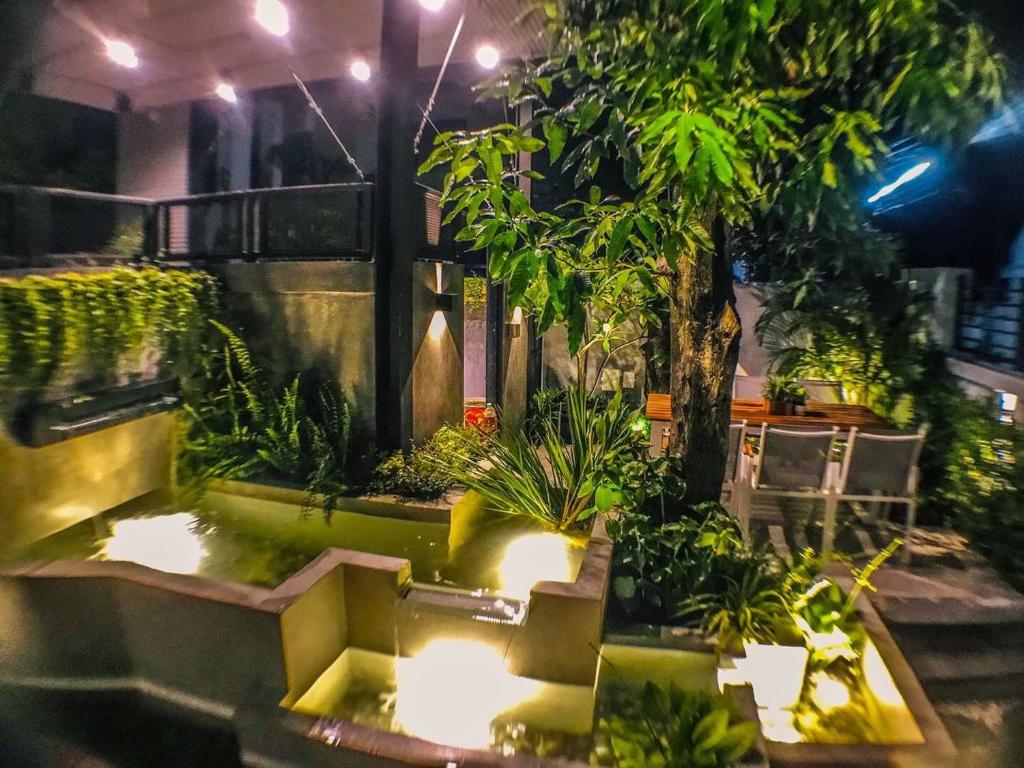 a room with a garden with plants and lights at Exclusive access to the whole garden. in Bangkok