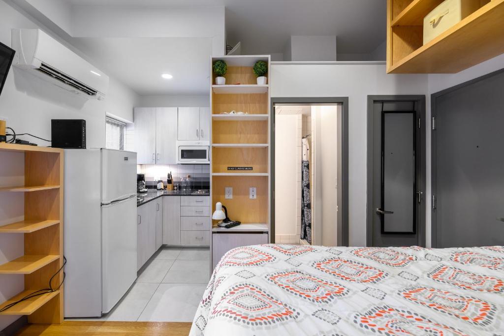a kitchen and a bedroom with a bed in a room at Small Fully Equipped Contemporary Studio Near MGH in Boston