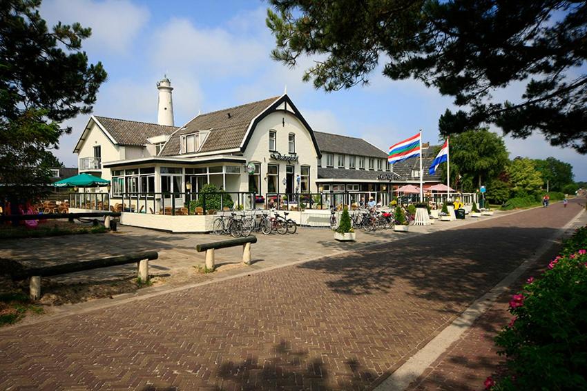 a large building with bikes parked in front of it at Hotel Cafe Restaurant Duinzicht in Schiermonnikoog