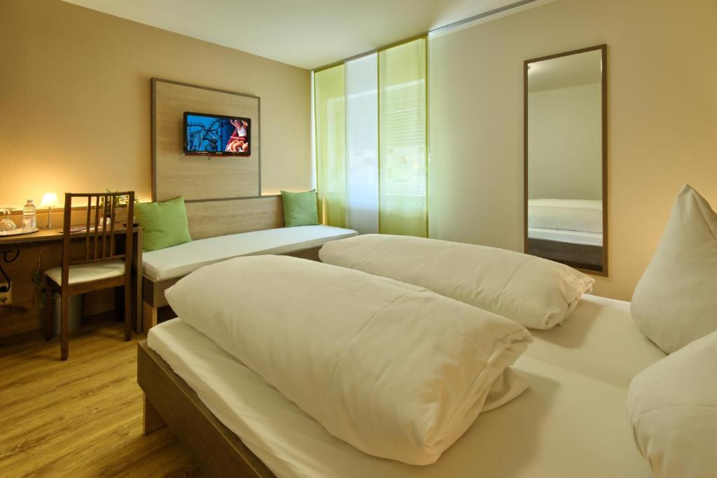Postel nebo postele na pokoji v ubytování Hotel Mythos