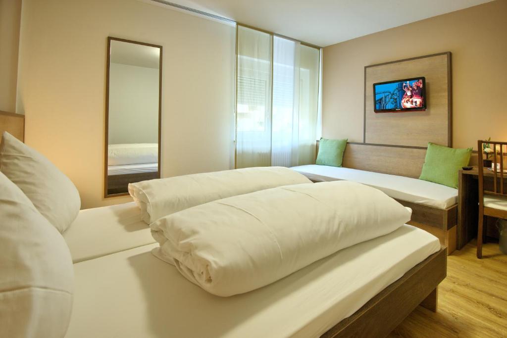 Postel nebo postele na pokoji v ubytování Hotel Mythos