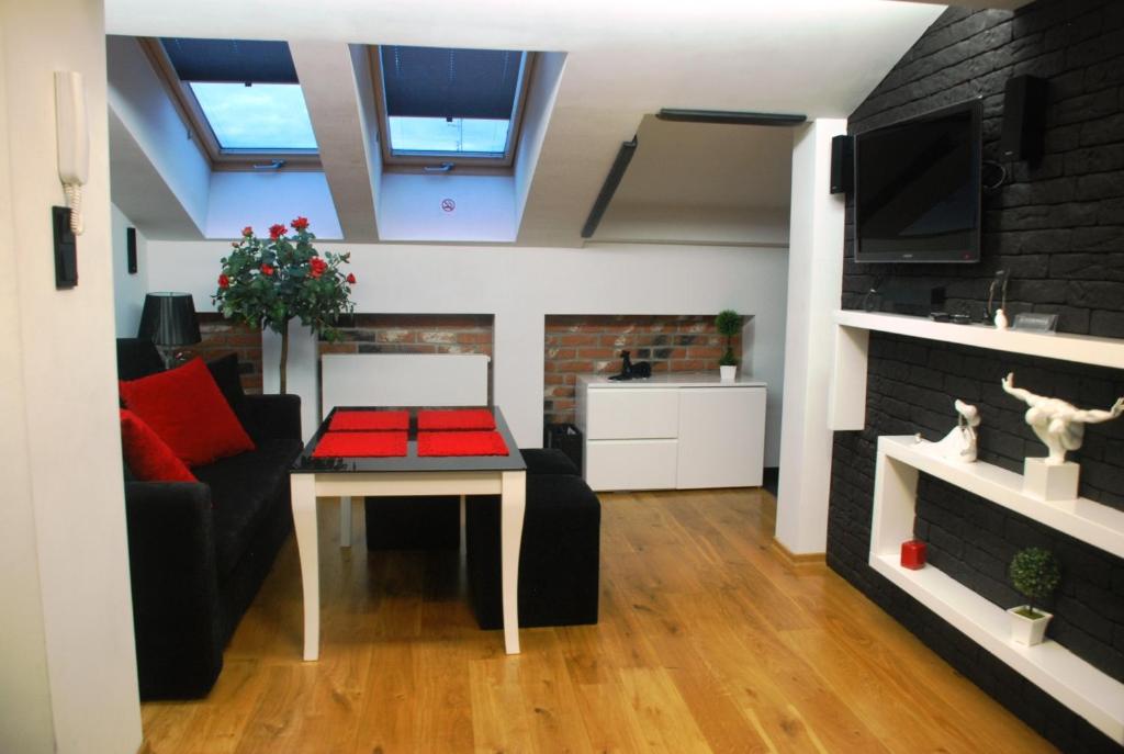 a living room with a couch and a table at Black & White in Kraków