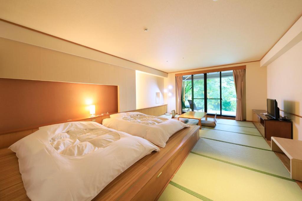 Postel nebo postele na pokoji v ubytování Hotel Shikisai