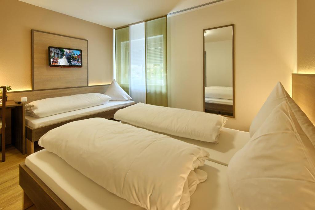 Postel nebo postele na pokoji v ubytování Hotel Mythos