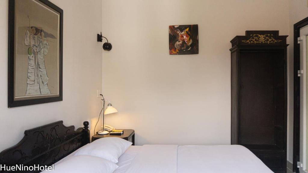 Postel nebo postele na pokoji v ubytování Hue Nino Hotel