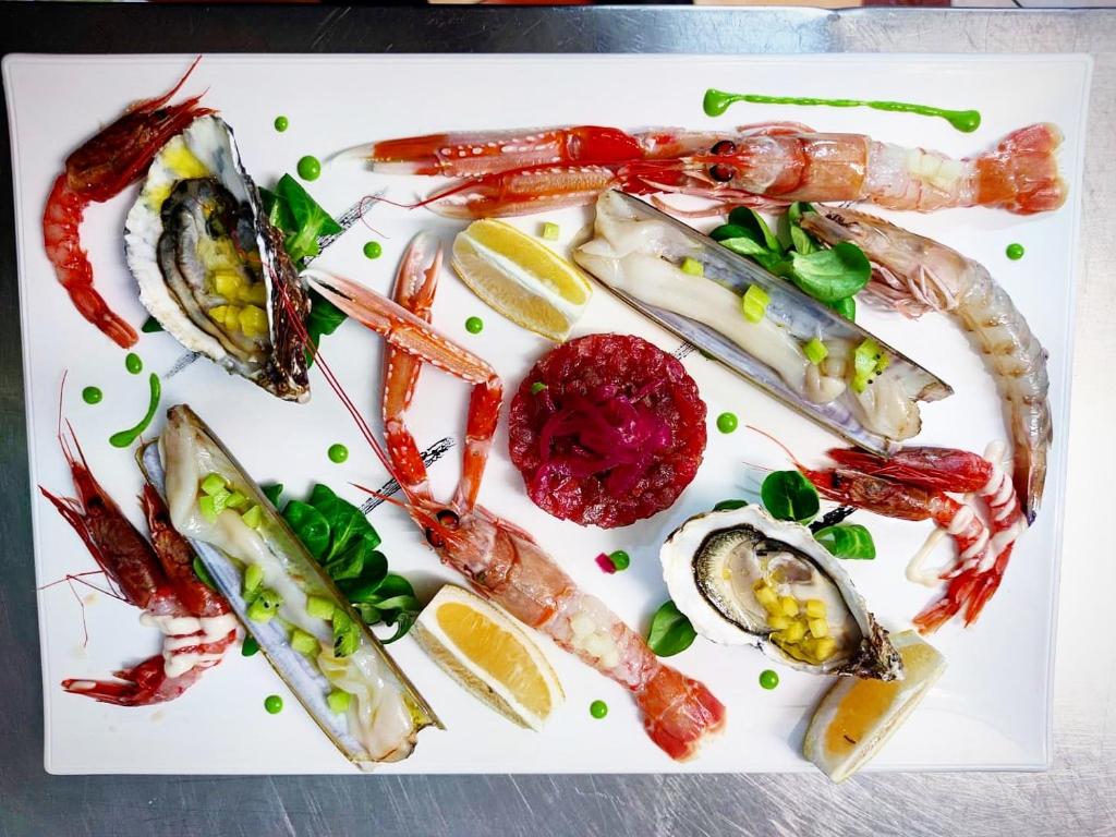 a plate of seafood on a white plate at Luna Convento Copanello B&B in Stalettì