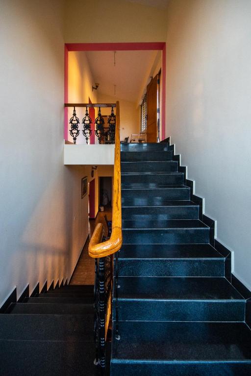 a staircase in a building with blue stairs at Hidden Heaven in Coonoor