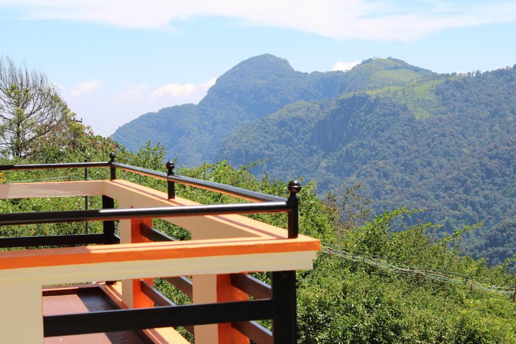 a balcony with a view of the mountains at Hidden Heaven in Coonoor