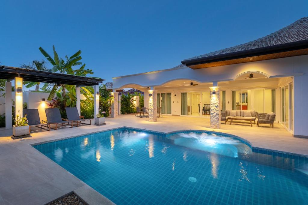 a swimming pool in the backyard of a house at Orchid Paradise Homes 404 in Hua Hin