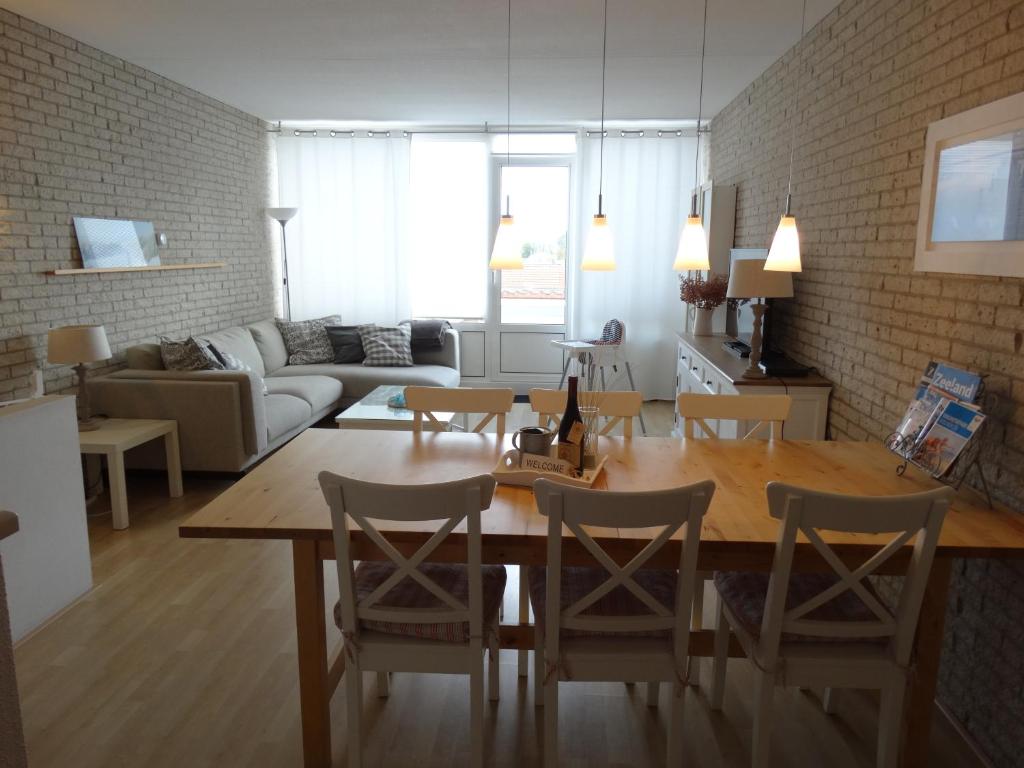 a kitchen and living room with a table and chairs at Vakantieappartment Duplex Aquadelta in Bruinisse