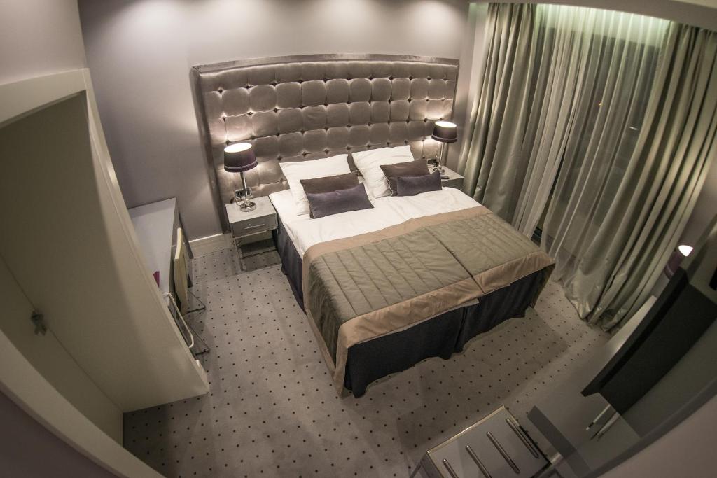 Postel nebo postele na pokoji v ubytování NovaWisła Resort & SPA