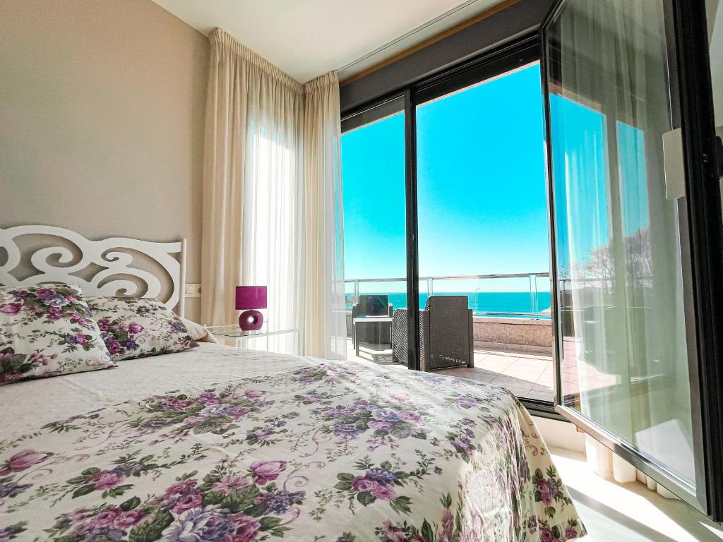 a bedroom with a bed with a view of the ocean at Apartamentos Santa María in Sanxenxo