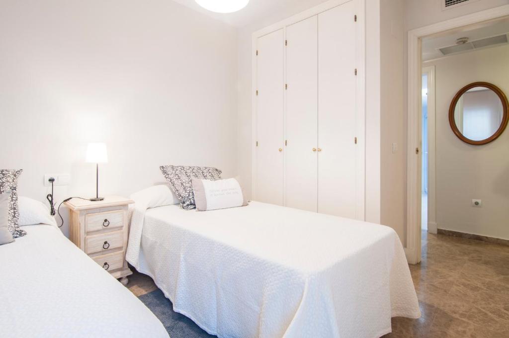 A bed or beds in a room at Sea view apartment, shared pools, Estepona, 60 m²