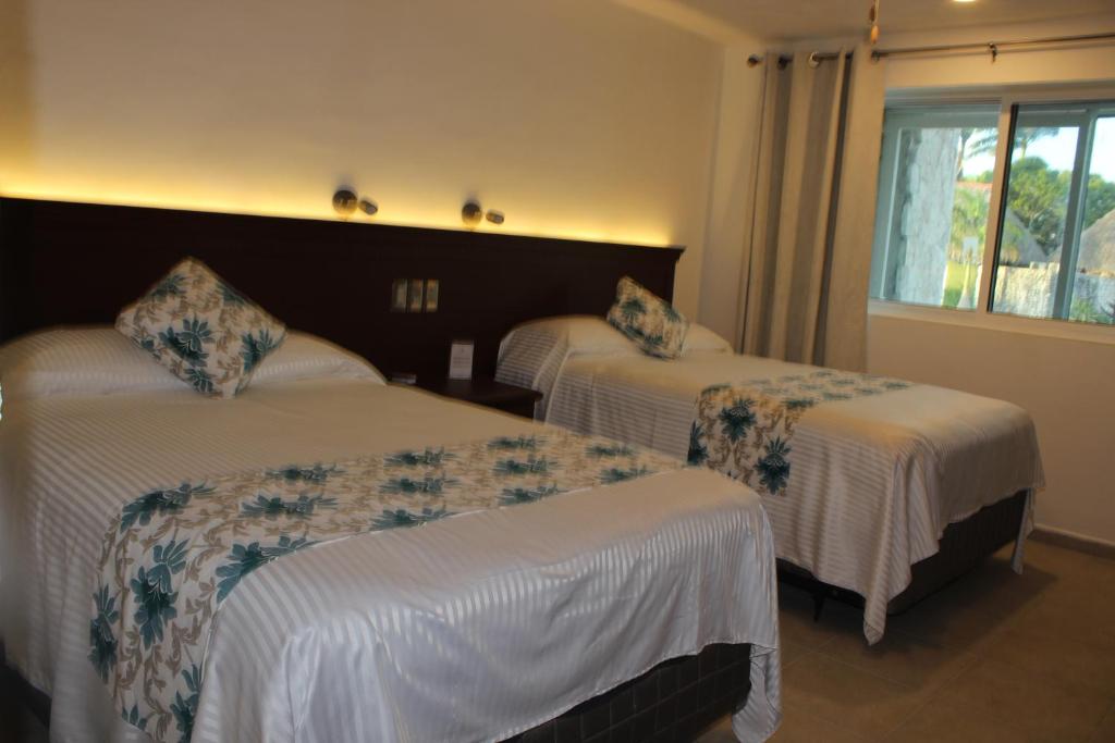 Postel nebo postele na pokoji v ubytování Hotel Puerta Chichen