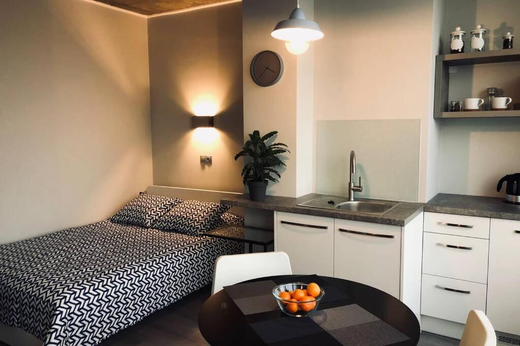 - une chambre avec un lit et une table avec des oranges dans l'établissement Bangu apartment with TERRACE in old town, à Klaipėda