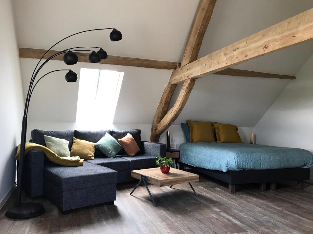 a living room with a couch and a bed at Hofstede Ter Biest in Zwalm