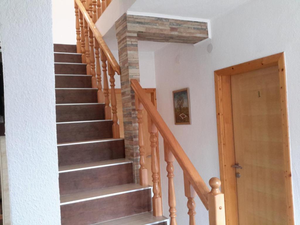 a staircase in a house with a stone wall at Lake House 1 in Plitvička Jezera