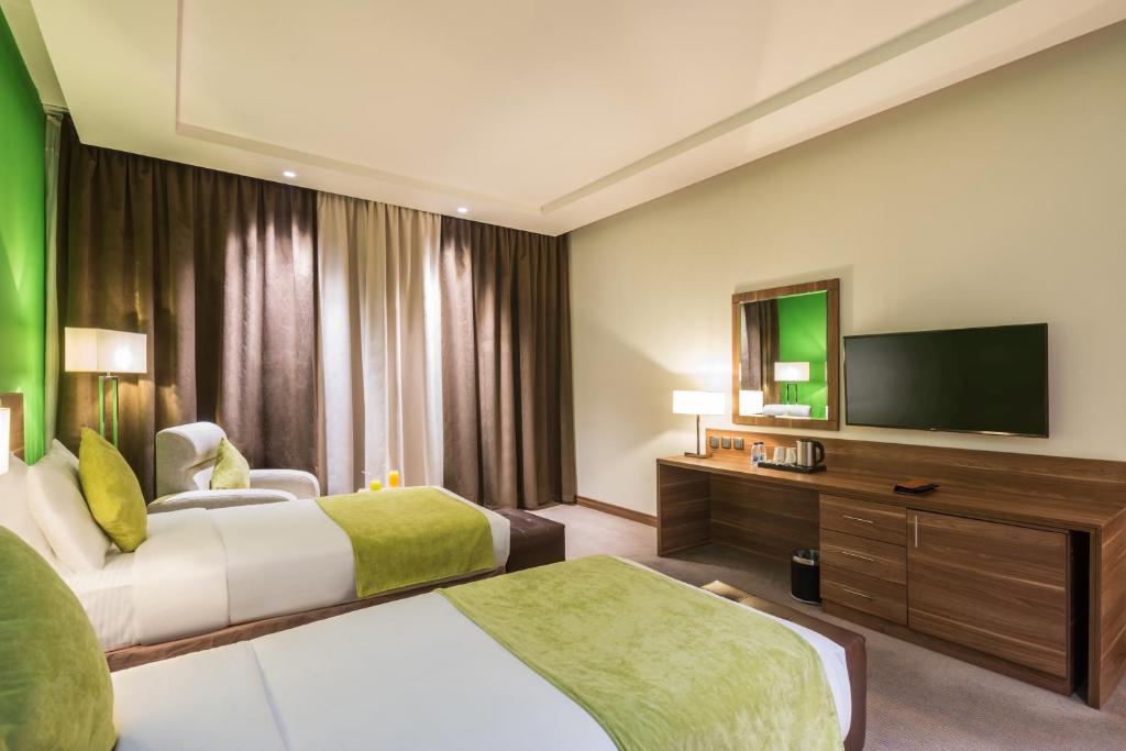 Postel nebo postele na pokoji v ubytování Mena Hotel Tabuk