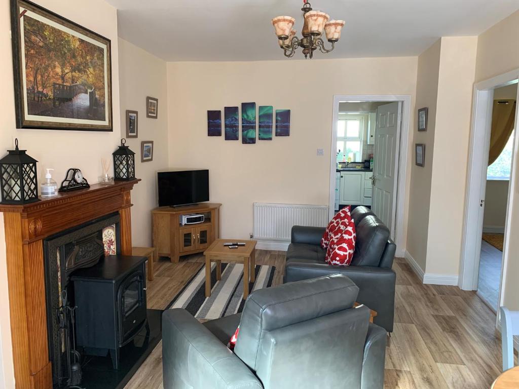 a living room with a couch and a fireplace at Mayfield House Holiday home in Ballinrobe