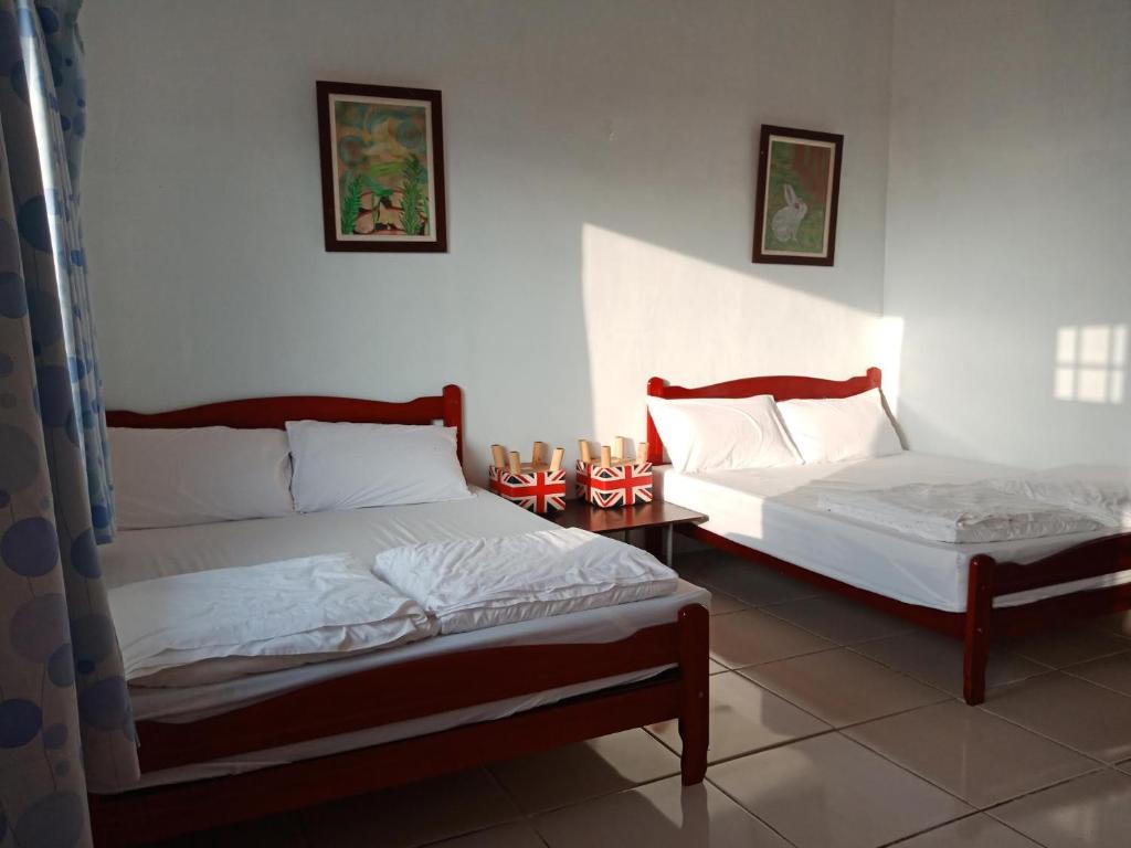 Postel nebo postele na pokoji v ubytování DoDoWu Homestay