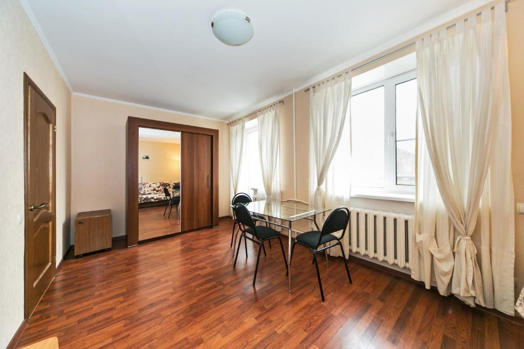 a dining room with a glass table and chairs at City Inn Apartment Sokolniki in Moscow