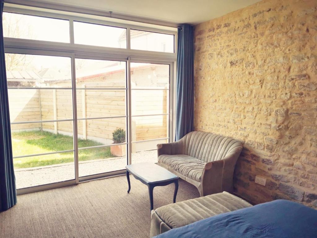 a living room with a couch and a window at Villa kahlo Omaha Beach in Colleville-sur-Mer