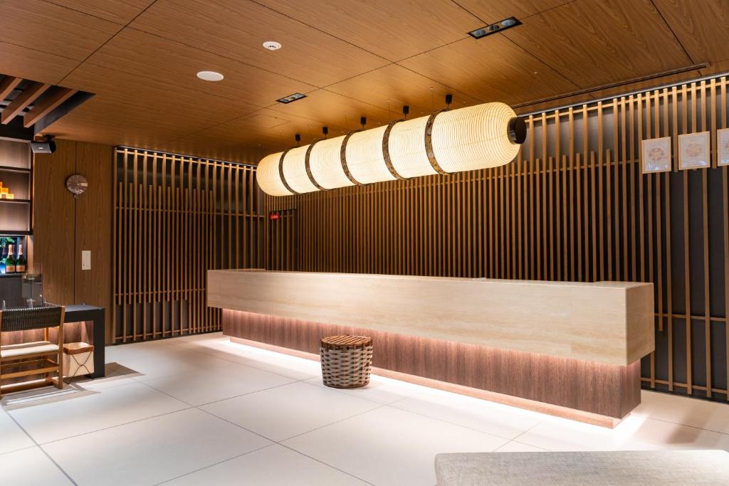 a lobby with a reception desk in a restaurant at Park Hotel Kyoto in Kyoto