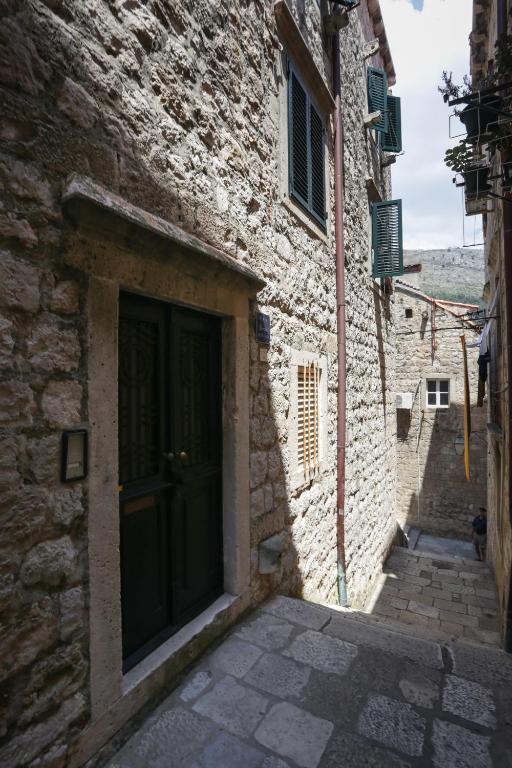 an alley with a door in a stone building at Old Town Princess Apartments in Dubrovnik