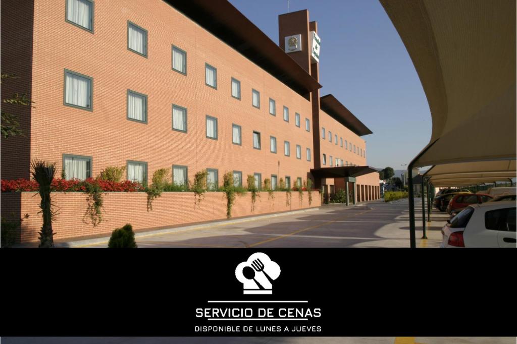 una representación de un edificio con una señal delante de él en Posadas De España Paterna, en Paterna