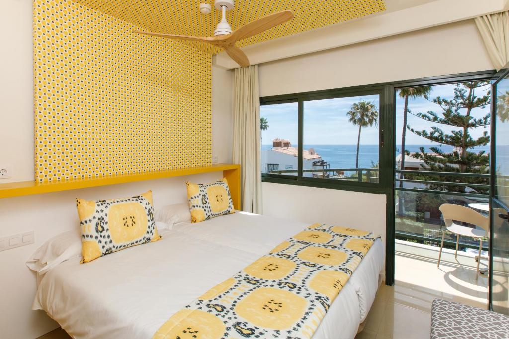a bedroom with a bed with a view of the ocean at Alsol Africana in Playa del Ingles