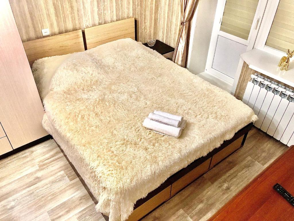 een bed met een harige deken erop in een kamer bij Квартира in Saratov
