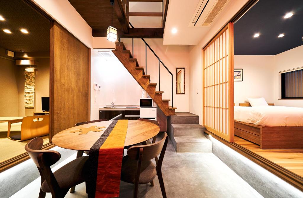 a room with a table and chairs and a bed at Bon in Kyoto