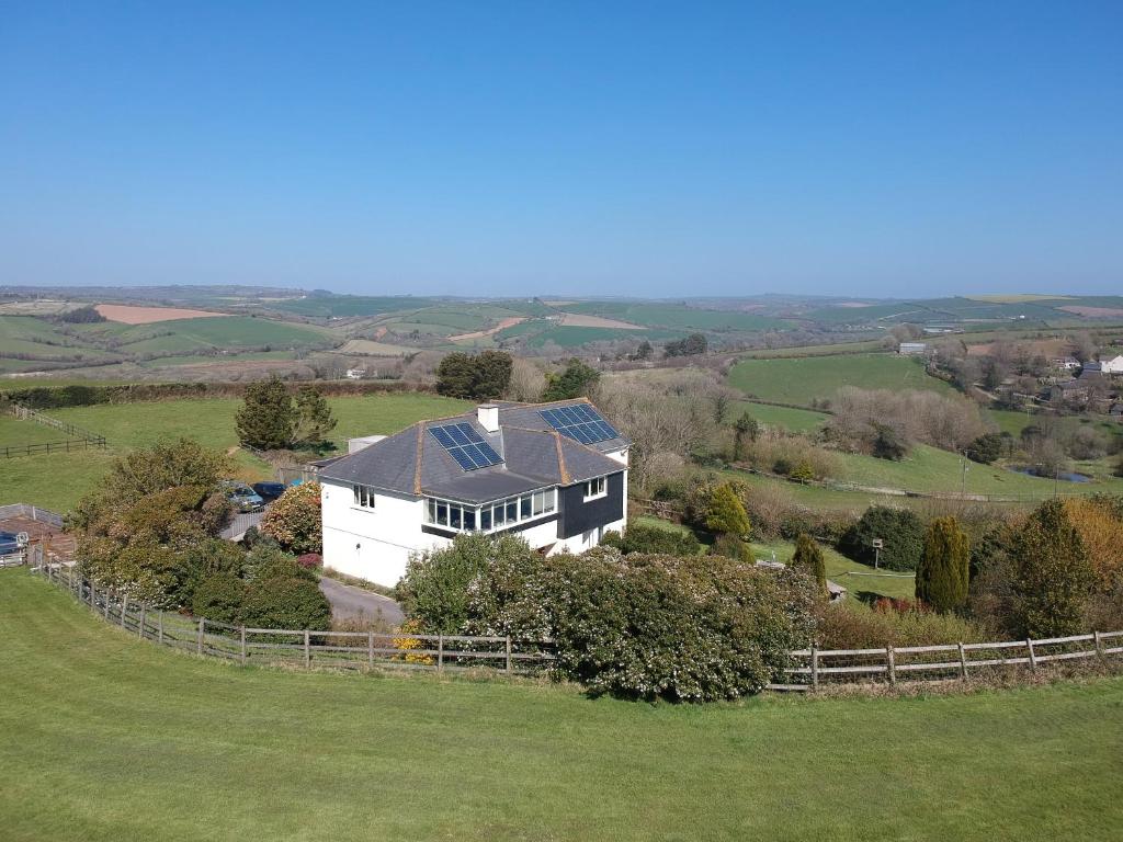 an aerial view of a house with solar panels on it at Merrifield House Devon in Kingsbridge