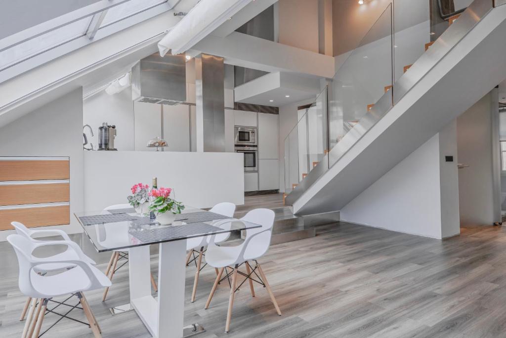 a dining room with a table and white chairs at Luxury Apartment in Centre in Prague