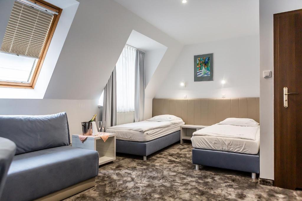 Postel nebo postele na pokoji v ubytování Hotel Jantar Wellness & Spa