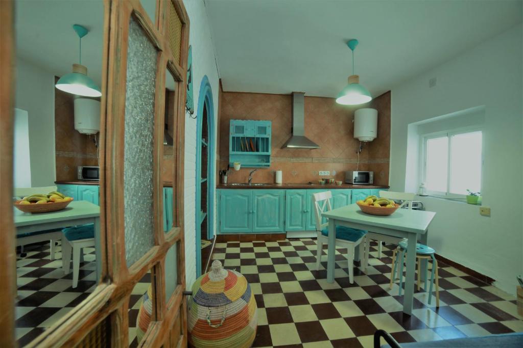 a kitchen with blue cabinets and a checkered floor at DUPLEX TARIFEÑO in the OLD TOWN in Tarifa