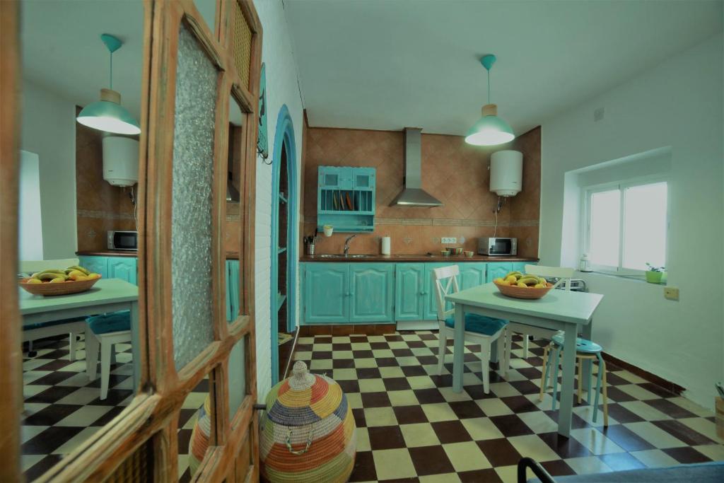 a kitchen with blue cabinets and a checkered floor at DUPLEX TARIFEÑO in the OLD TOWN in Tarifa