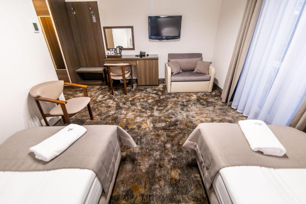 Postel nebo postele na pokoji v ubytování Hotel Jantar Wellness & Spa