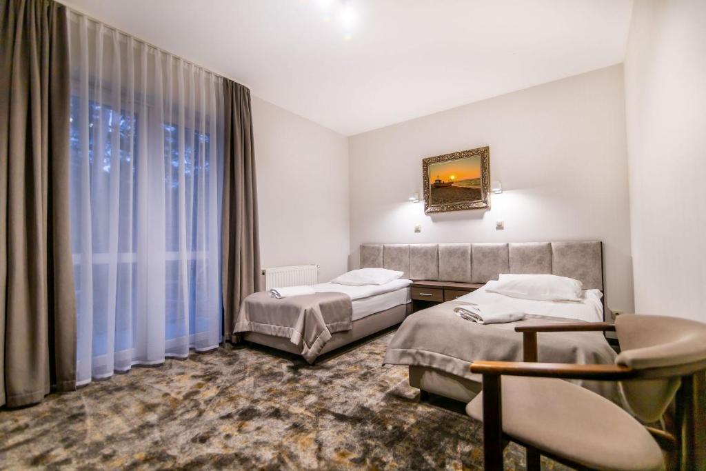Postel nebo postele na pokoji v ubytování Hotel Jantar Wellness & Spa