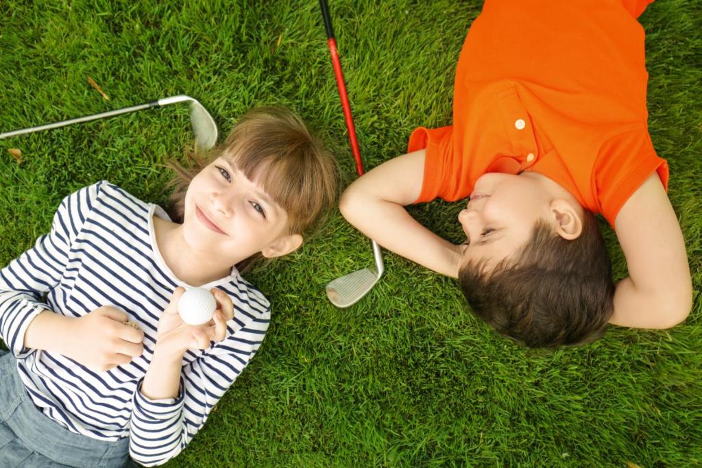 two young children laying on the grass at Clayton Hotel & Leisure Club Sligo in Sligo