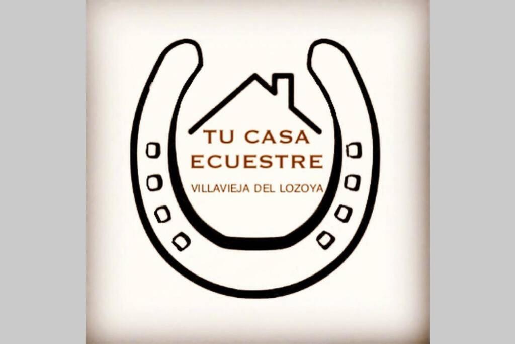 a bottle of uci casa expertise with a hand gesture at Tu Casa Ecuestre in Villavieja del Lozoya