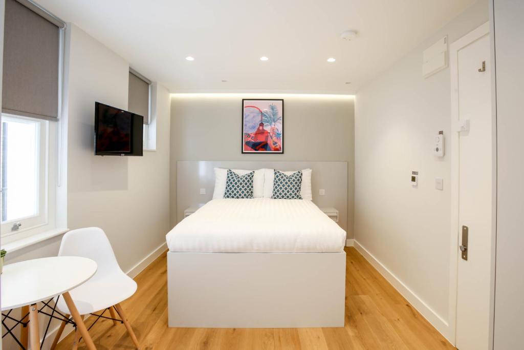 Postel nebo postele na pokoji v ubytování StayPrime Kensington Serviced Apartments