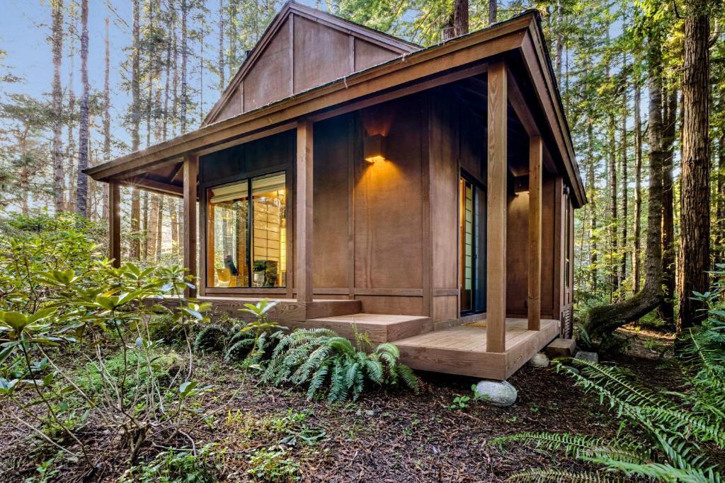 una pequeña cabaña de madera en medio de un bosque en The Tea House en Sea Ranch