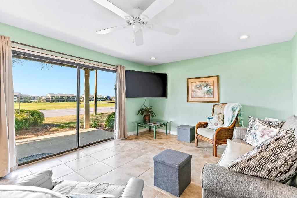 a living room with a couch and a tv at Seascape Golf Villas 6A in Destin