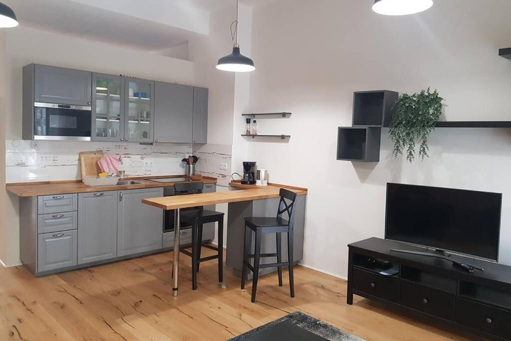 a kitchen with a counter and a table with chairs at Tempelhoferfeld in Berlin